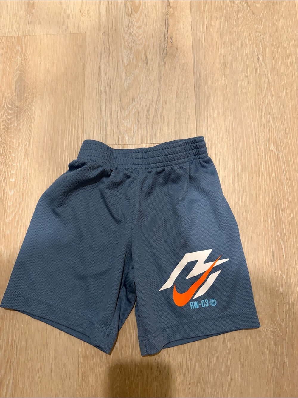 Nike Blue Kids Athletic Shorts with Orange Swoosh